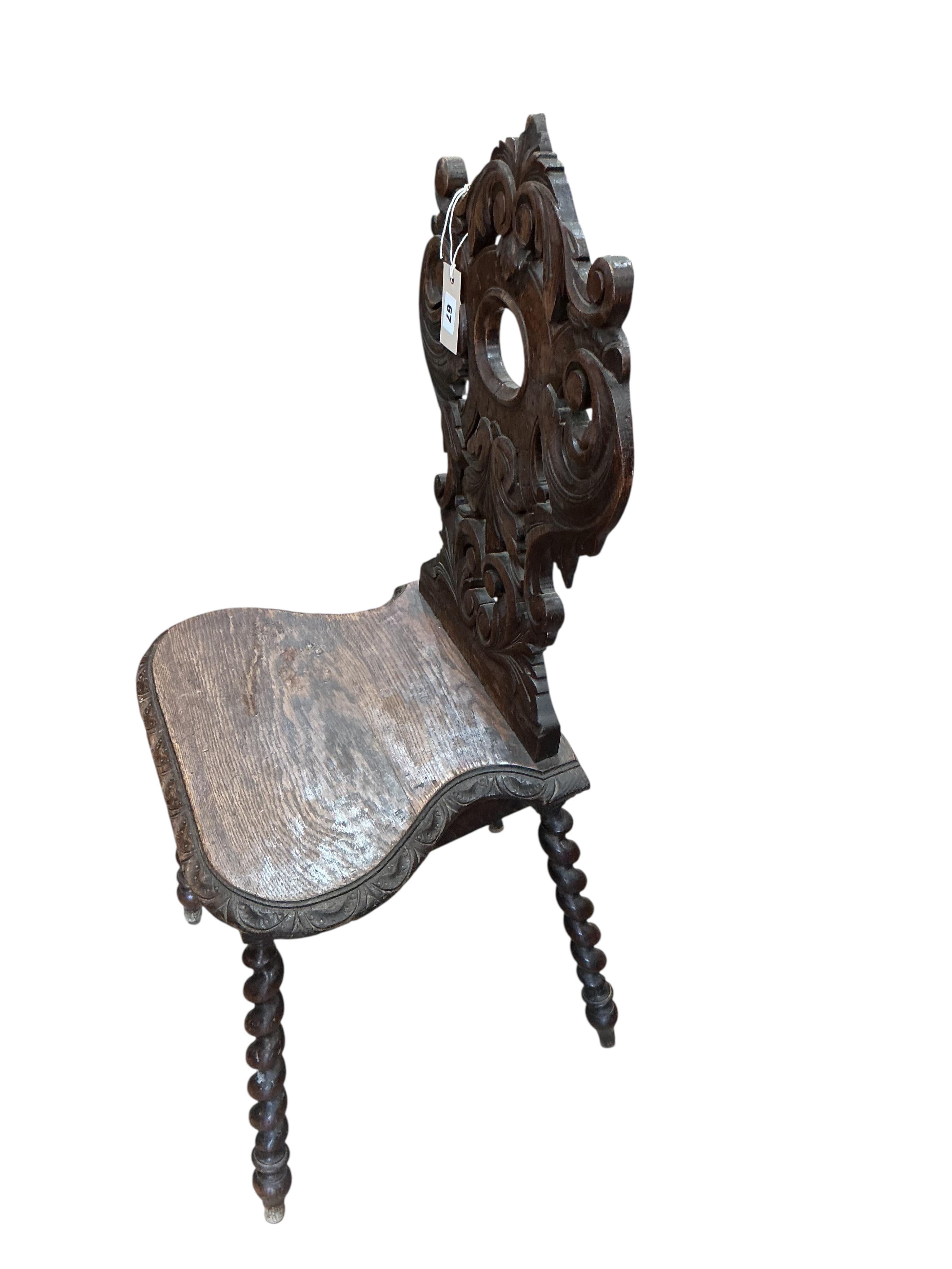 A pair of 19th century carved oak hall chairs, width 45cm, depth 34cm, height 94cm